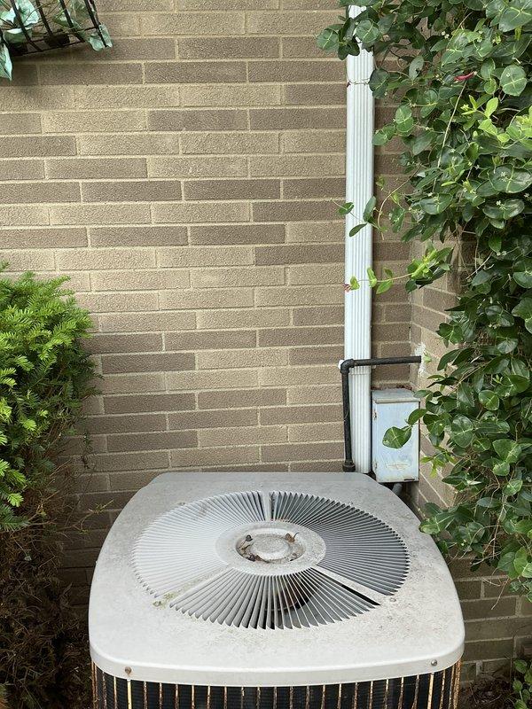 Conducted estimate for complete HVAC system replacement including outdoor condensing unit and attic-mounted air handler. Inspected existing aging condenser unit showing significant weathering, oxidation, and rust staining on exterior panels and grilles. Evaluated current system configuration including electrical disconnect, refrigerant lines, and condensate drainage. Documented equipment condition and access requirements for attic air handler installation scheduled for morning appointment.