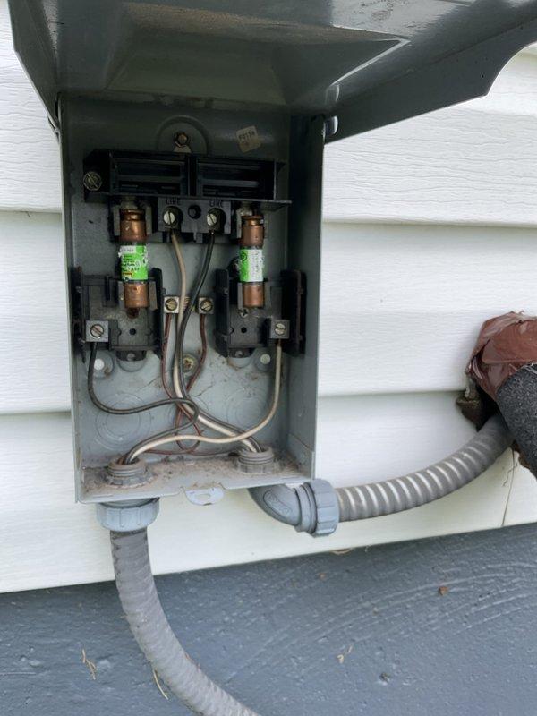 Responded to no-cooling call on 12-year-old Rheem air conditioning system. Upon arrival, performed visual inspection of outdoor condensing unit and electrical disconnect box. Found blown fuses in exterior disconnect, preventing power to compressor and condenser fan motor. Replaced both fuses in disconnect box, restored power to unit, and verified system operation with successful startup and proper cooling cycle.