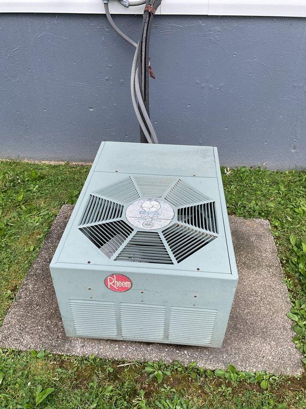 Responded to no-cooling call on 12-year-old Rheem air conditioning system. Upon arrival, performed visual inspection of outdoor condensing unit and electrical disconnect box. Found blown fuses in exterior disconnect, preventing power to compressor and condenser fan motor. Replaced both fuses in disconnect box, restored power to unit, and verified system operation with successful startup and proper cooling cycle.