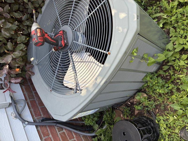 Responded to service call for outdoor air conditioning condenser unit experiencing operational issues. Upon inspection, diagnosed failed dual run capacitor affecting both compressor and condenser fan motor performance. Removed access panel to electrical compartment and disconnected power supply. Replaced defective capacitor with new OEM-spec component, ensuring proper microfarad ratings for both compressor and fan circuits. Verified all electrical connections, secured wiring, and tested unit operation. System restored to full functionality with normal amperage draws and proper cooling cycle operation.