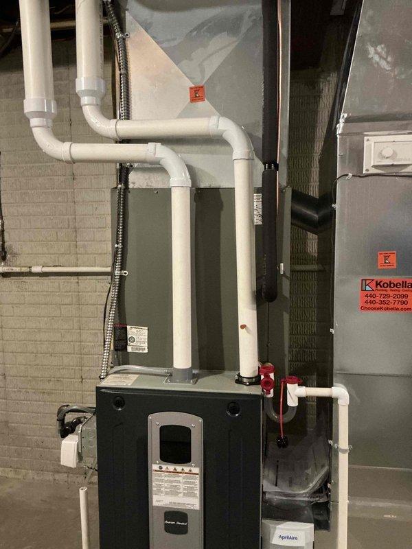 Provided comprehensive estimate for complete HVAC system replacement of 19-year-old equipment. Documented existing furnace, air handler, and associated components including PVC venting, condensate drainage system, refrigerant lines, and electrical connections for replacement quote preparation.