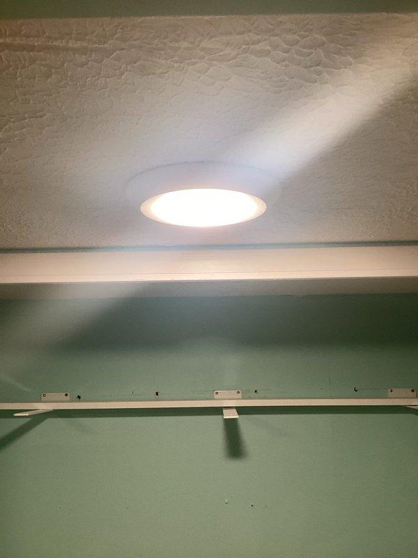 Upgraded existing 2-gang old work box to a 3-gang configuration to accommodate expanded switching requirements. Sourced constant power from newer wiring in attic space, ran new power feed to switch location, and installed 12-3 wire to ceiling fan location to enable independent fan and light control. Installed ceiling fan in centered position within living room for optimal air circulation and functionality.