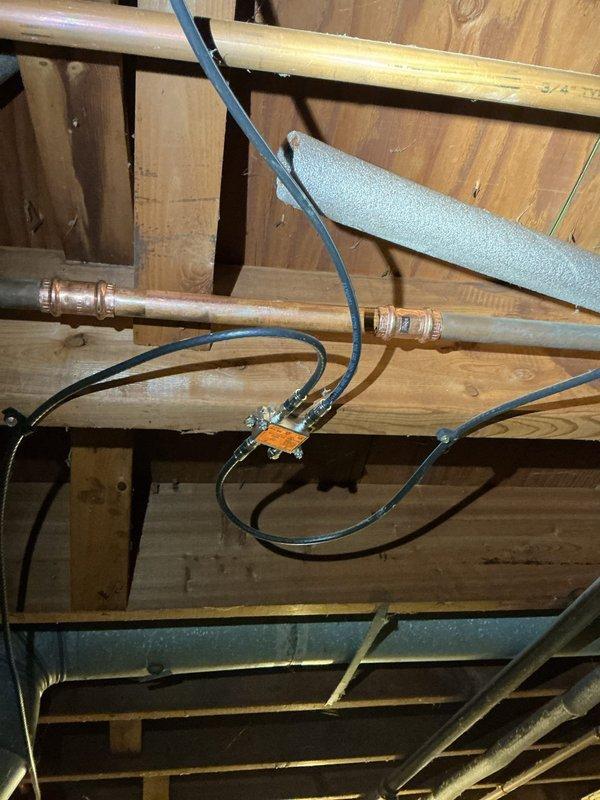 Responded to a water leak on the main waterline feeding the water softener system. The existing clamp connection had deteriorated due to rust, causing an active leak that required immediate attention. Replaced the failed rusted clamp with a new secure connection on the copper waterline, ensuring proper seal and flow to the water softener. Verified system integrity and confirmed no additional leaks present upon completion.