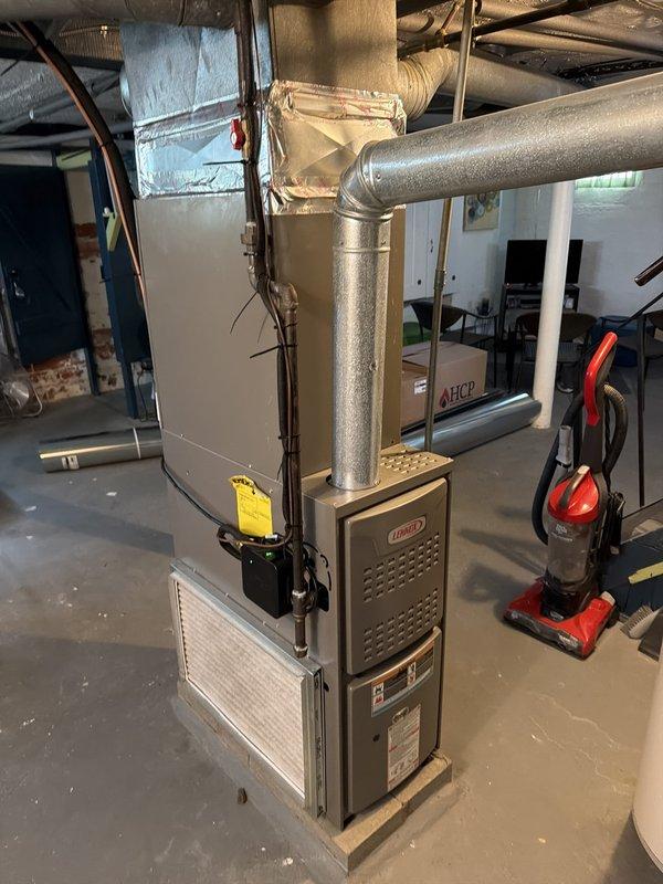 Completed installation of new Lennox HVAC system including furnace unit and A/C coil in residential basement utility room. Connected and secured all ductwork, including horizontal supply plenum and flexible insulated distribution lines. Installed PVC condensate drain piping from unit base along floor to proper termination point. Verified all electrical connections, tested system operation, and ensured proper airflow throughout the installation.