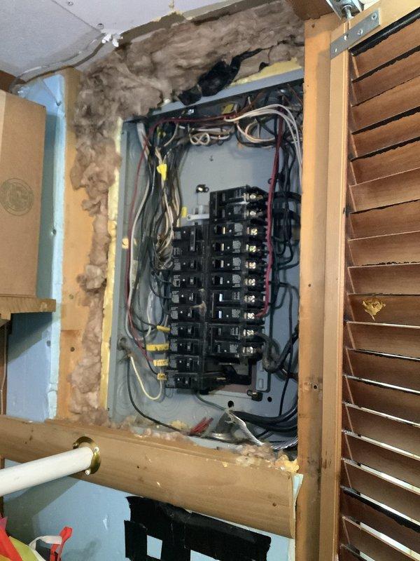 Responded to service call for intermittent power loss with circuits tripping under load. Accessed main electrical panel through wall cavity and diagnosed overloaded circuits causing breakers to trip when multiple appliances operated simultaneously. Inspected all breaker connections, identified loose wire terminations and improper circuit loading, then redistributed loads across available circuits and secured all connections to manufacturer specifications. Tested all circuits under load conditions to verify stable operation throughout the property.