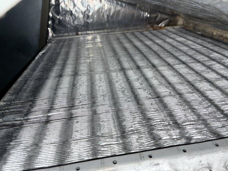Completed MVP cooling maintenance visit on 11-year-old HVAC system. Upon inspection, discovered significant frost and ice accumulation on evaporator coils, indicating restricted airflow or potential refrigerant issues. Documented wet condensation on coil fins and substantial ice buildup across multiple coil layers with debris trapped in frost. Photographed internal components including evaporator coil assembly, flexible ductwork, and foil-faced insulation in attic installation. System requires immediate attention to address icing condition and restore proper cooling operation.