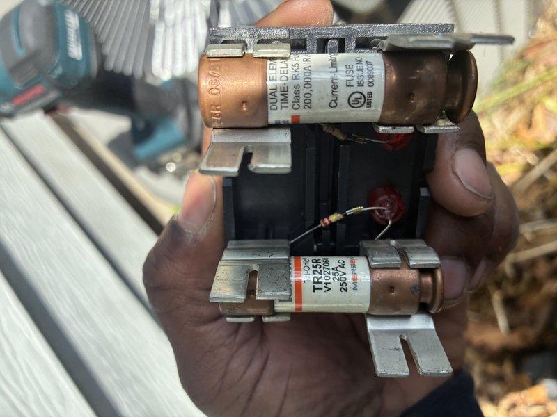 Completed routine HVAC maintenance on outdoor cooling unit, which included inspection of condenser coil showing significant dirt accumulation and streaking patterns requiring attention. Inspected and evaluated electrical components including dual element time delay fuses rated at 200 amps, disconnect assembly, and associated wiring connections to ensure proper system operation and safety compliance.