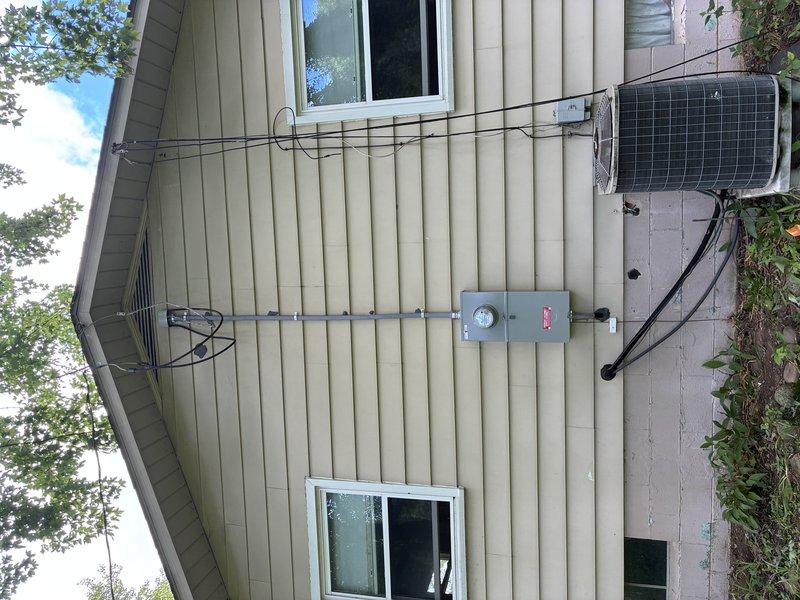 Responded to emergency service call for damaged 200-amp exterior electrical service equipment that was ripped from the residence. Replaced weatherhead, service entrance conductors, meter base, and installed code-required emergency exterior disconnect. Re-fed main electrical panel with proper conductor sizing, separated grounds and neutrals to meet current NEC standards, and upgraded main service grounding system to code compliance. Collected deposit and ordered necessary materials for completion.