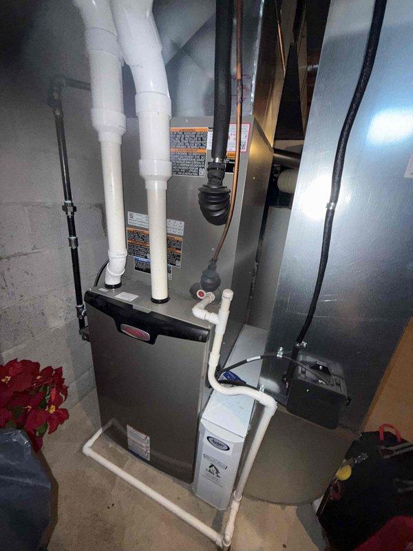 Completed annual MVP cooling maintenance visit on one-year-old system. Performed comprehensive inspection of outdoor condenser unit and indoor air handler components. Condenser coil exhibited heavy accumulation of dirt, dust, and debris throughout fin surfaces, requiring thorough cleaning to restore proper heat transfer efficiency. Inspected indoor furnace and air handler assembly in basement mechanical room, verified all PVC venting connections, drainage pan placement, and electrical connections. System operational following maintenance procedures.