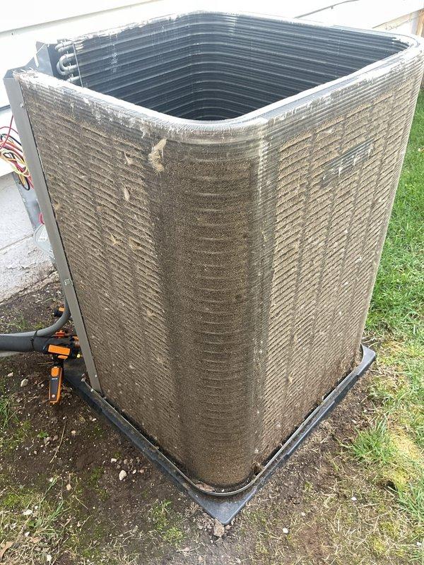 Responded to high indoor humidity reading of 70% reported by thermostat. Upon inspection, found outdoor condenser unit heavily contaminated with dirt, dust, and debris accumulation on exterior casing and coil surfaces, significantly restricting airflow and reducing system efficiency. Used diagnostic equipment to assess system performance and confirmed compromised heat exchange capability due to blocked condenser coils affecting overall cooling and dehumidification capacity.