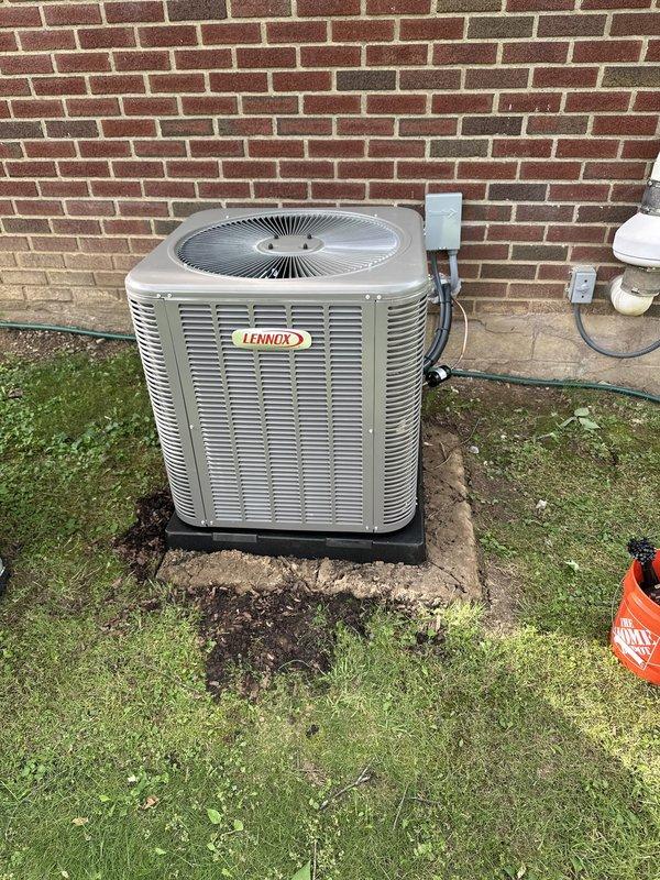 Completed installation of Lennox air conditioning system including outdoor condensing unit and evaporator coil. Mounted condenser on concrete pad against exterior brick wall with proper clearances, installed electrical disconnect box with FLNR 25A dual fuse protection, and ran electrical conduit from disconnect to unit. Verified all electrical connections, tested system operation, and confirmed proper amperage draw within manufacturer specifications.