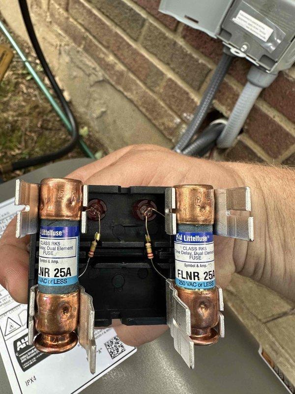 Completed installation of Lennox air conditioning system including outdoor condensing unit and evaporator coil. Mounted condenser on concrete pad against exterior brick wall with proper clearances, installed electrical disconnect box with FLNR 25A dual fuse protection, and ran electrical conduit from disconnect to unit. Verified all electrical connections, tested system operation, and confirmed proper amperage draw within manufacturer specifications.