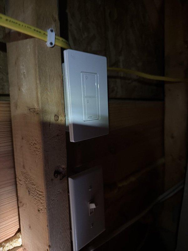 Installed exterior floodlight on garage to illuminate extended driveway area. Sourced power from existing garage door opener circuit and ran wiring through attic space to new fixture location. Mounted customer-supplied floodlight without motion detector or photocell as requested. Installed Lutron Caseta smart switch in attic for primary control and added remote switch access near garage door for convenient operation. All wiring secured to code standards within attic framing, switch plates installed, and system tested for proper functionality.