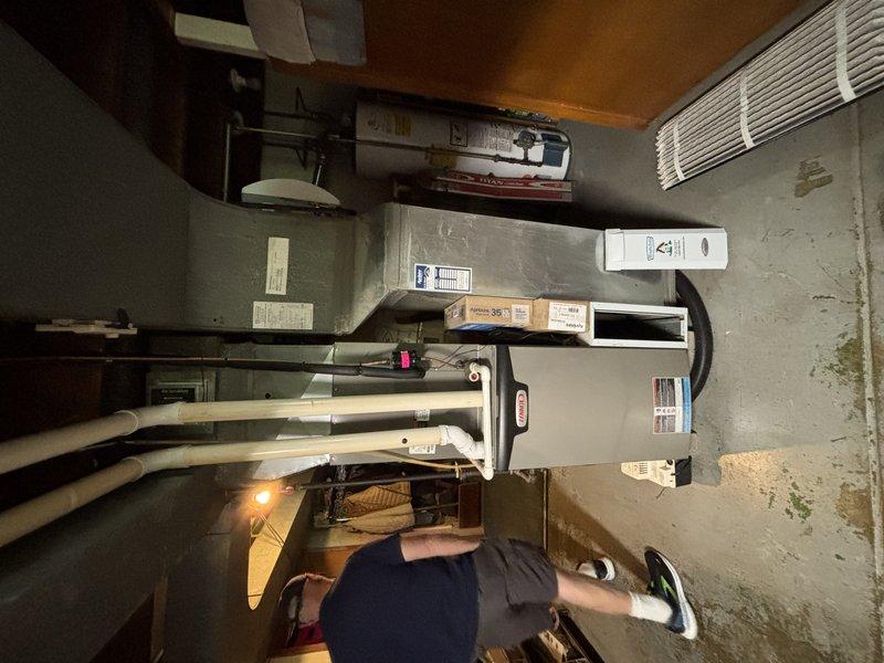 Completed MVP cooling maintenance visit on residential HVAC system. Performed comprehensive inspection of indoor furnace/air handler unit located in basement utility room and outdoor condenser unit. Verified proper operation of all system components including refrigerant lines, drainage systems, electrical connections, and airflow. Documented equipment condition through photographs showing both indoor and outdoor units in good working order with appropriate clearances maintained around outdoor condenser despite surrounding vegetation.