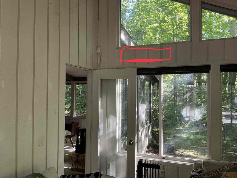 Conducted mini split system estimate for residential installation. Assessed interior mounting location in sunroom area with extensive glazing and exterior wall placement for condenser unit. Documented existing exterior line set installation on building with gray-green siding. Customer requested estimate review before proceeding with previously quoted installation work.