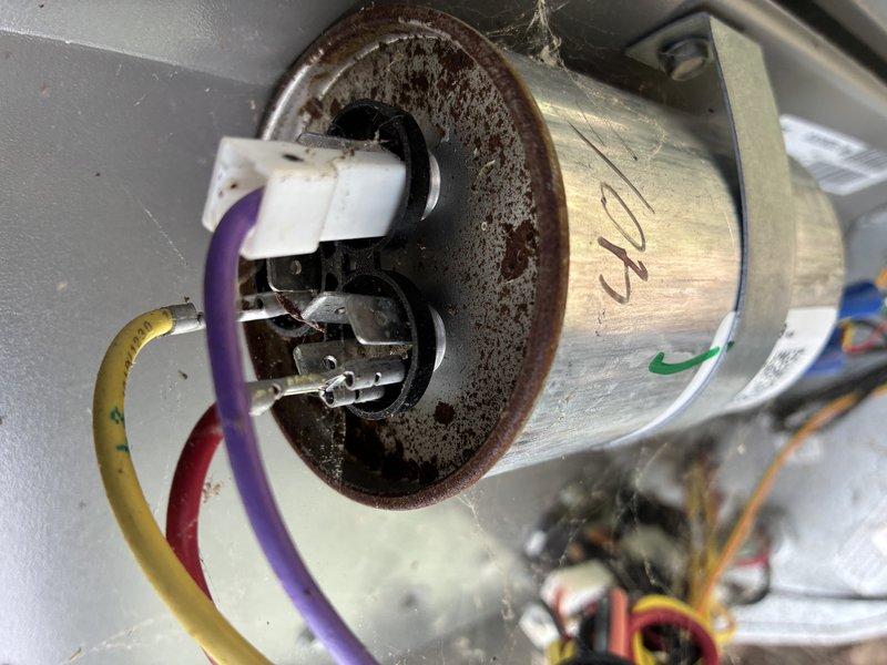 Completed MVP cooling maintenance visit on 2-year-old system. Performed comprehensive system diagnostics using digital clamp meter to verify proper electrical operation and amperage draw. Inspected blower motor assembly and noted significant rust and corrosion present on motor mounting plate, though motor housing and electrical connections remain intact and functional. Documented all electrical readings and component conditions with photographs. Verified colored wire connections (purple, red, yellow) are secure and capacitor is operational. System operating within normal parameters at time of inspection, though corrosion on mounting plate should be monitored for future maintenance planning.