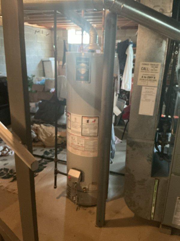 Responded to service call for leaking kitchen sink and customer-supplied faucet installation. Upon arrival, performed diagnostic assessment which revealed active water leak requiring access through ceiling to locate source and assess piping infrastructure. Cut access opening in ceiling to expose plumbing lines and identified leak point at pipe connection. Repaired leak by securing compromised fitting and verified water supply lines were properly sealed. Proceeded with removal of existing kitchen faucet and installed customer-supplied replacement unit, ensuring proper connections to hot and cold water supply lines with appropriate sealing and torque specifications. Tested all connections for leaks under pressure and confirmed proper operation of new faucet including handle function and water flow. Inspected basement area and water heater connections as part of comprehensive plumbing system assessment to ensure no additional leak sources were present. All work completed successfully with