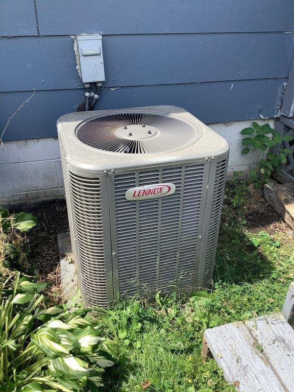 Responded to no cooling complaint on Lennox residential air conditioning system. Upon arrival, performed diagnostic evaluation of outdoor condensing unit and found system operational but requiring standard maintenance due to debris accumulation on louvers and components. Inspected electrical disconnect, verified proper operation, and confirmed unit functionality after service.