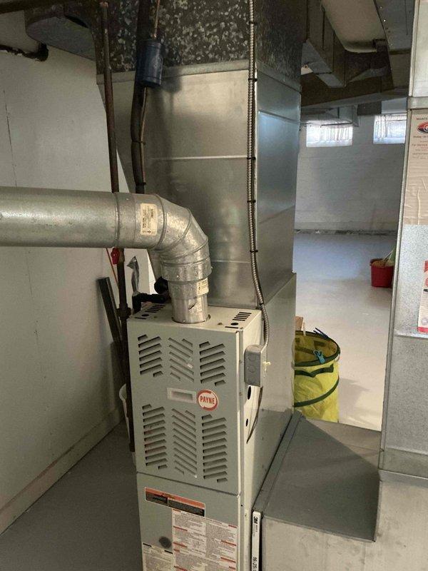 Conducted comprehensive assessment of existing HVAC system in residential basement mechanical room for complete system replacement estimate. Evaluated current Payne furnace installation, associated ductwork configuration, and air distribution infrastructure to provide customer with buy-one-get-one promotional pricing options for new air conditioning unit with discounted furnace replacement. Documented existing equipment layout, plenum connections, and available space for new system installation through photographic records.