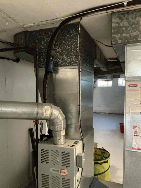 Conducted comprehensive assessment of existing HVAC system in residential basement mechanical room for complete system replacement estimate. Evaluated current Payne furnace installation, associated ductwork configuration, and air distribution infrastructure to provide customer with buy-one-get-one promotional pricing options for new air conditioning unit with discounted furnace replacement. Documented existing equipment layout, plenum connections, and available space for new system installation through photographic records.