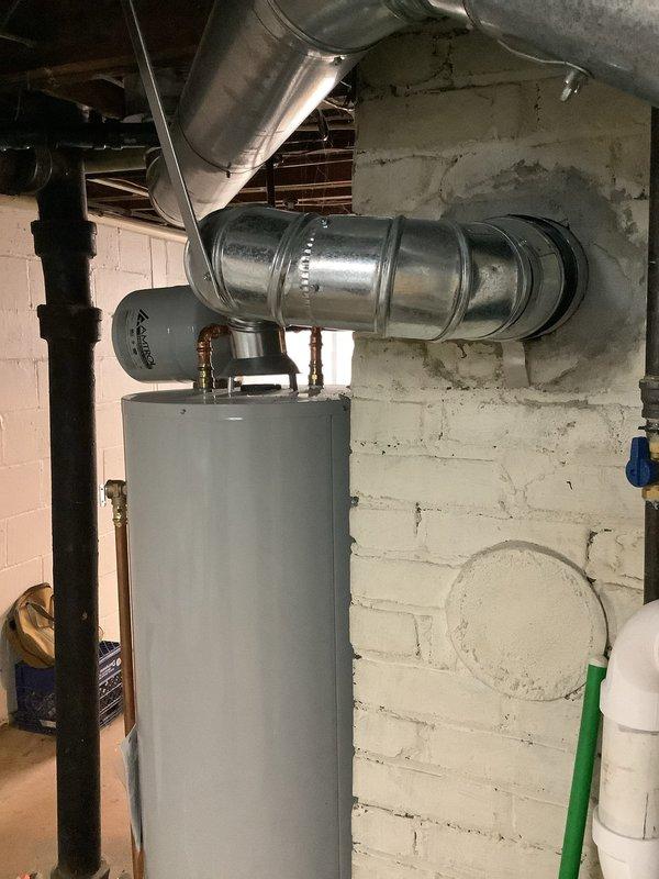 Responded to warranty callback regarding water heater installation from 2023 that was flagged during home inspection as not meeting code requirements. Upon arrival, performed comprehensive inspection of the unit and all associated components including copper piping connections, expansion tank, venting system, and mounting configuration. Documented current installation conditions with detailed photography showing water heater positioned against painted masonry wall with copper supply lines, brass fittings, expansion tank, and galvanized metal ductwork connections. Verified all plumbing connections, reviewed clearances, checked TPR valve discharge piping, examined venting configuration, and assessed compliance with current plumbing code standards. Installation found to meet applicable code requirements at time of original installation.