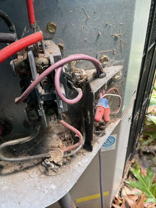 Responded to no cooling complaint on 27-year-old residential HVAC system for second opinion evaluation. Upon inspection, found outdoor condensing unit with severely corroded contactor assembly, extensive environmental deterioration, and heavy accumulation of debris on electrical components. Contactor showed significant oxidation and rust on contacts and mounting surface, with aged wiring insulation exhibiting wear and discoloration. Indoor furnace unit inspected and access panel opened to verify blower motor operation and internal component condition. Given the advanced age of the system and extent of deterioration observed on critical electrical components, provided assessment of equipment condition and replacement recommendations.