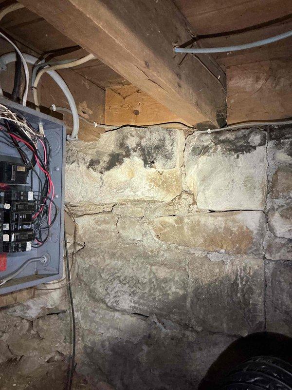 Conducted on-site electrical assessment for 10kW standby generator installation at a small residential property with 100-amp service panel located in basement. Evaluated existing electrical infrastructure, documented current panel configuration and available capacity, and photographed panel conditions including wiring arrangement and surrounding environment to determine feasibility for basic power backup system covering essential circuits.