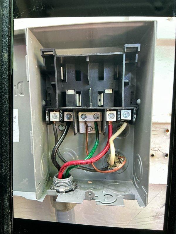 Replaced defective electrical disconnect box for HVAC system. Removed old gray metal enclosure and installed new disconnect with proper fused switch mechanism. Reconnected all electrical wiring including power conductors and ground wire to appropriate terminals, verified secure connections, and confirmed proper operation of disconnect switch.