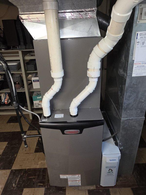 # HVAC Install - Complete System

Completed installation of a new 90% efficiency Lennox furnace and air conditioning system. Installed furnace unit in basement utility area with proper PVC venting configured in dual-pipe design for intake and exhaust. Secured all ductwork connections with metallic components and appropriate insulation. Mounted outdoor condenser unit with proper clearances and connected electrical service including 25-amp fused disconnect assembly. Verified all safety labels and manufacturer specifications are visible and accessible. System tested and operational upon completion.