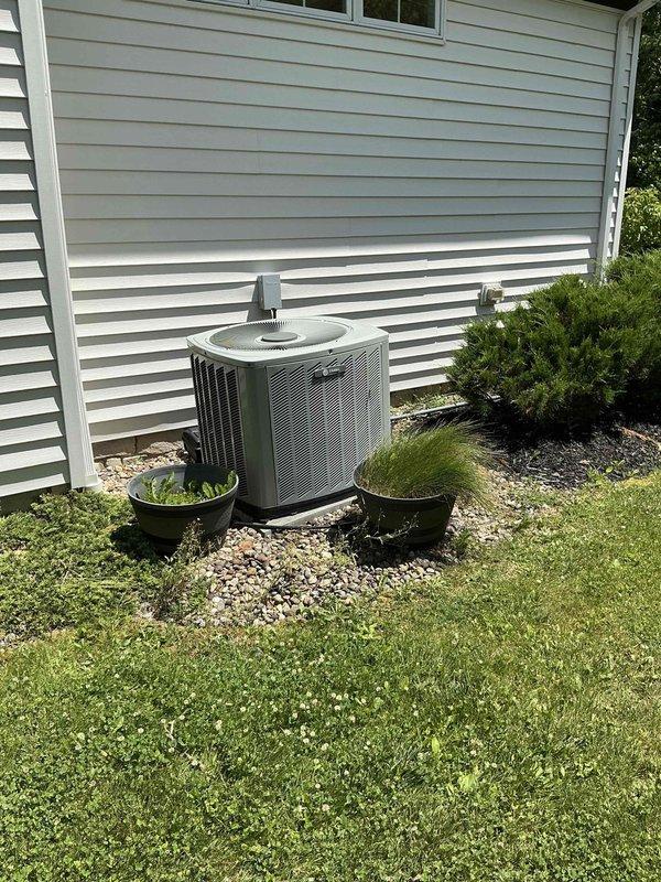 Responded to no cooling call and conducted comprehensive assessment of existing HVAC system including outdoor air conditioning unit and indoor furnace equipment. Documented current equipment conditions with detailed photography of both exterior condensing unit mounted on gravel pad and interior basement furnace system with exposed components. Prepared complete replacement estimate for furnace and air conditioning system to address cooling failure and overall system performance concerns.