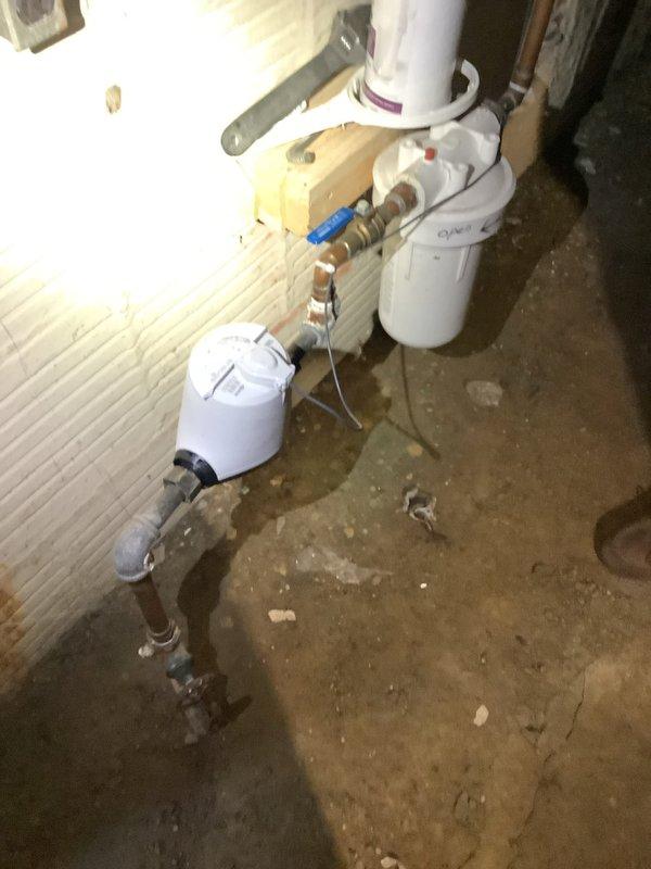 Responded to a service call for a bathtub that was not draining properly. Upon inspection, identified that access to the drain line would require opening the ceiling below the fixture to properly diagnose the issue. Documented the existing water treatment system in the basement area, including dual-tank filtration setup with associated copper and PVC plumbing connections. Examined damaged ceiling section where drywall had been removed, revealing exposed framing and horizontal PVC drain line running through the cavity. Recommended camera inspection of the drain line once additional access is provided. Scheduled follow-up visit to provide repair quote after property owner completes drywall removal for full access to the affected plumbing.