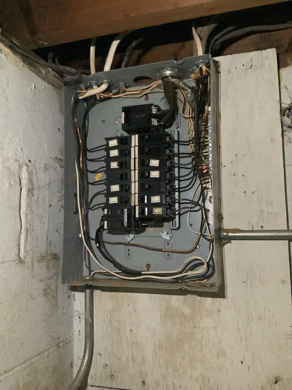 Conducted on-site assessment and provided second quote for complete rewiring of 1400 square foot residential property. Evaluated existing electrical service including exterior meter base, main service entrance conductors, and interior main distribution panel with dual rows of circuit breakers. Documented current electrical infrastructure condition to determine scope of rewiring project.
