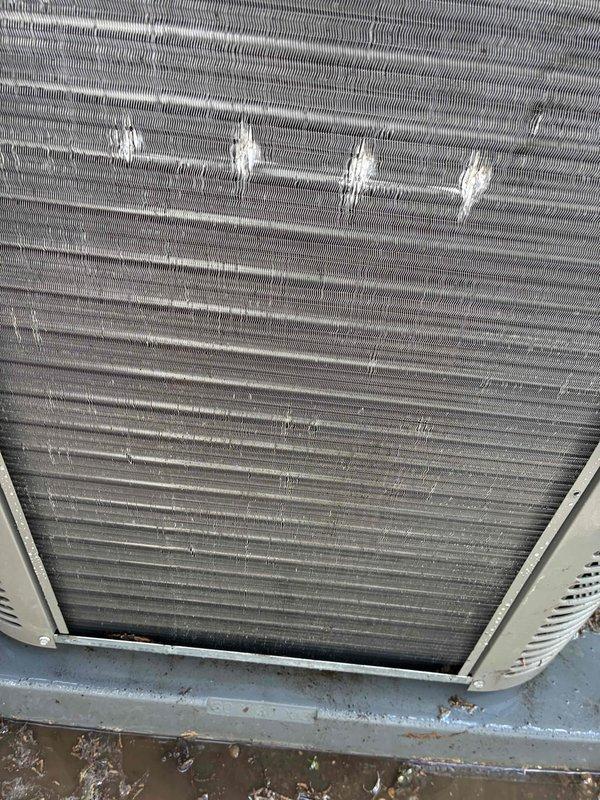 Completed routine AC tune-up on 3-year-old system. Inspected condenser coil and found moderate dirt accumulation and debris between fins with some bent fins affecting airflow; documented current condition with photos showing need for future cleaning to maintain efficiency. Measured supply air temperature at 59.9°F, confirming system is cooling properly and operating within normal parameters.