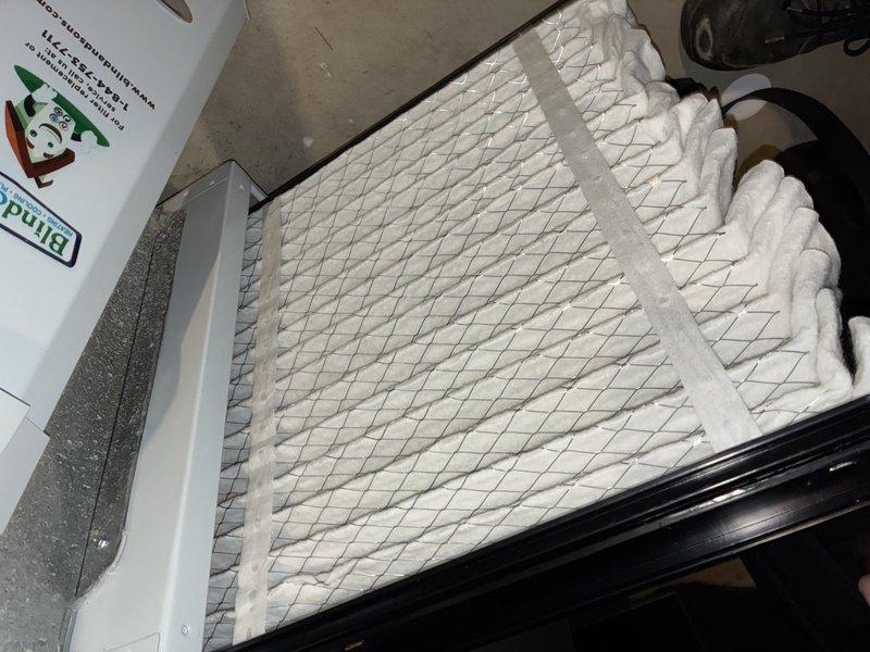 Responded to service call for 6-year-old air conditioning system operating below optimal performance. Upon inspection, found dirty air filter restricting airflow and condensate drain line showing significant buildup of biological matter and mineral deposits. Replaced air filter with new pleated media filter and cleared condensate drain line to restore proper drainage and prevent potential water damage or system shutdown.