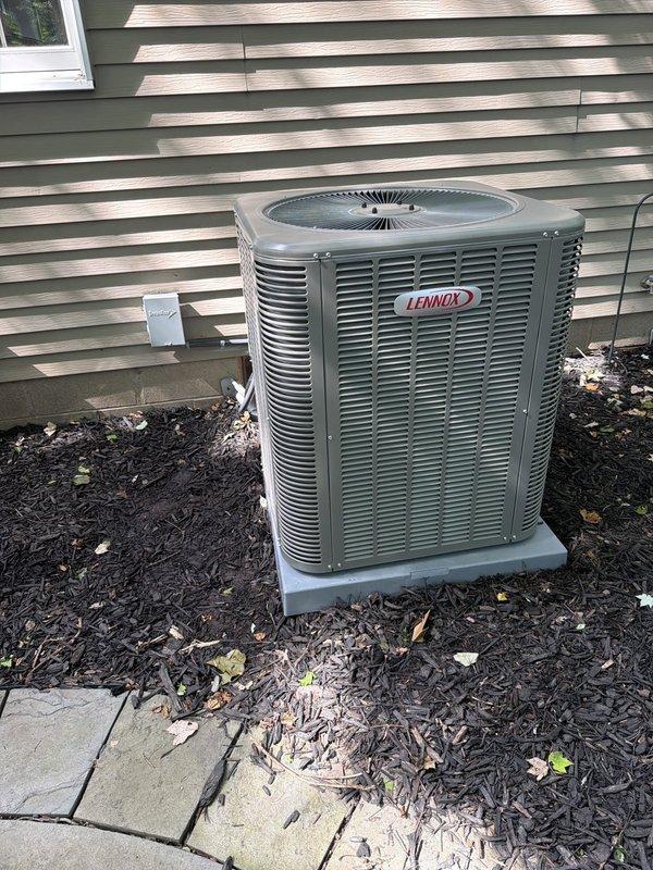 Completed installation of Lennox air conditioning condenser unit with matching evaporator coil as part of a two-stage HVAC system upgrade. The outdoor condenser was positioned on a concrete pad against the exterior wall with proper clearances maintained for airflow and serviceability. Installed 30-amp fused disconnect with LHR-rated fuses for electrical protection and code compliance. All electrical connections were terminated per manufacturer specifications, refrigerant lines were properly insulated and secured, and the system was tested for proper operation upon completion.