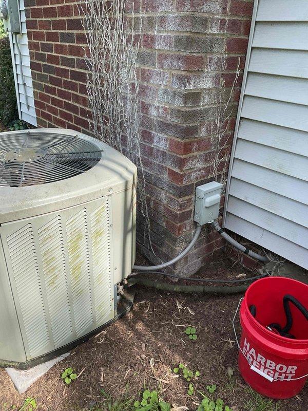 Completed standard AC tune-up on outdoor condensing unit. Performed comprehensive system inspection, checked electrical connections and conduit, verified proper operation of condenser fan, and assessed overall unit condition. Unit showing age-related weathering and discoloration on exterior panels but functioning within normal parameters.