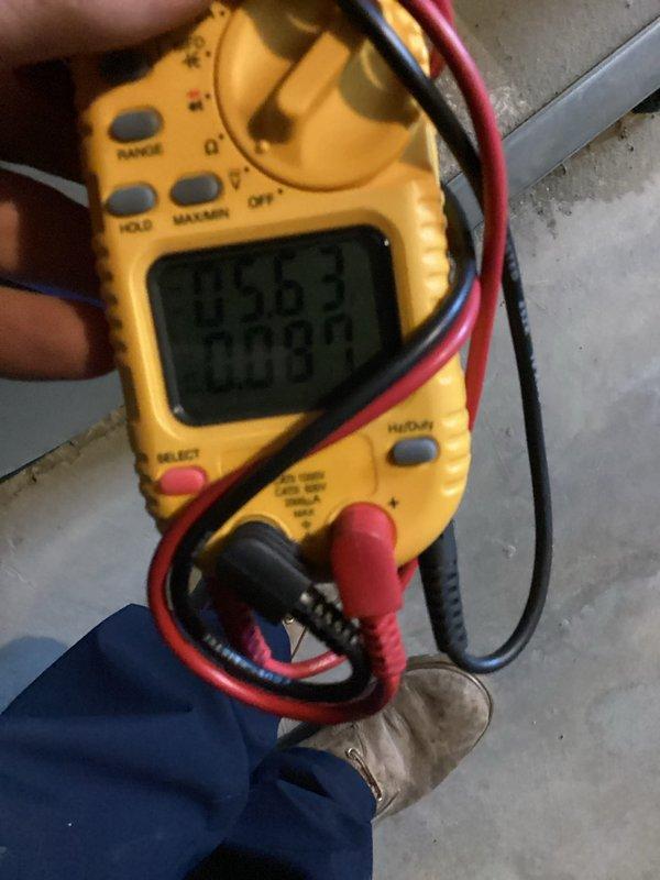 Performed comprehensive air conditioning maintenance on a system at least two years old. Conducted diagnostic testing using digital multimeter to verify electrical readings and measured system temperatures with digital thermometer, recording supply air temperature of 59.2°F. Inspected ductwork for condition assessment and potential cleaning requirements, noting visible wear patterns on metal surfaces and ventilation components.