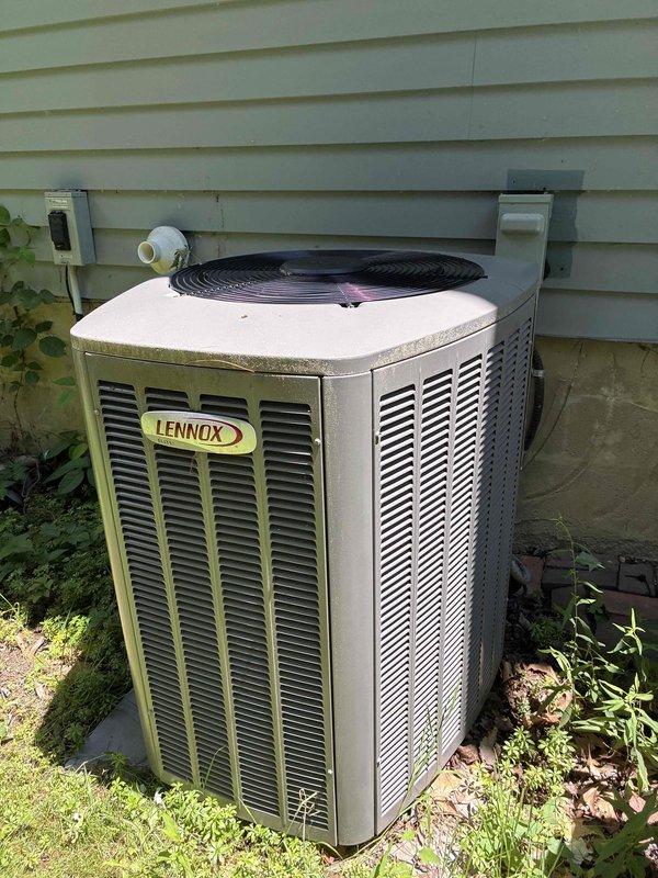 Completed AC tune-up on Lennox outdoor condensing unit. Performed standard maintenance including inspection of all components, electrical connections, and refrigerant levels. Identified and documented significant frost buildup on suction line with temperature reading of 69.6°F, indicating potential low refrigerant charge or restricted airflow issue requiring further diagnosis. Replaced Aprilaire 5001 air filter per customer request. System operational at time of departure but recommend follow-up service to address icing condition on refrigerant lines.