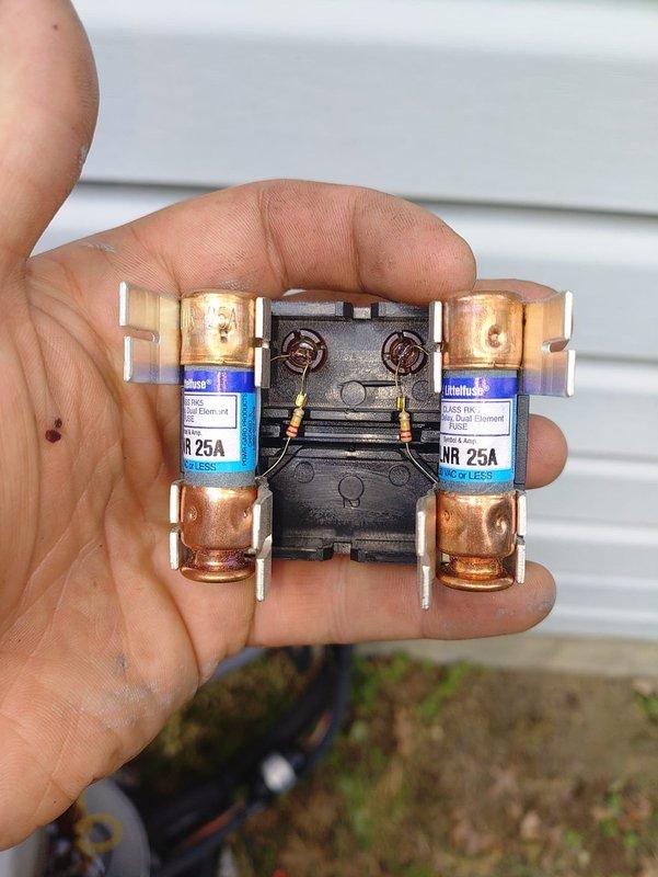 Completed installation of a 93% efficiency furnace, air conditioning system, and condensate pump at a mobile home structure. Installed new electrical disconnect with dual 25-amp fuses and contactor assembly to provide proper power supply and overcurrent protection for the outdoor condensing unit. Routed condensate drain line through exterior siding with proper PVC piping and elbow configuration to ensure adequate drainage away from the structure foundation.