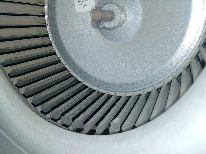 Completed scheduled MVP cooling maintenance visit. Performed comprehensive inspection of HVAC blower assembly and air filtration system. Examined squirrel-cage centrifugal blower wheel, noting normal operational wear on mounting hardware and light dust accumulation on housing surfaces. Inspected pleated radial air filter element and verified proper installation of concentric mounting rings and central fastener. All components photographed and documented for maintenance records. System operational and functioning within normal parameters.