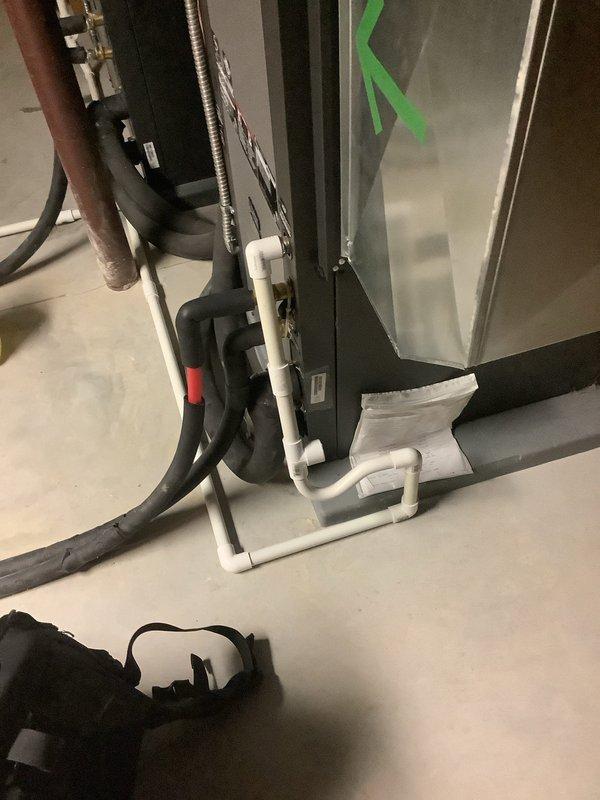 Completed MVP recurring cooling maintenance on two HVAC units. During inspection, discovered active water leakage from condensate drain line with visible pooling on floor beneath horizontal PVC piping section. Addressed drainage issue, inspected condensate trap and drain line connections, verified proper operation of both systems, and confirmed all electrical components and controls functioning correctly.