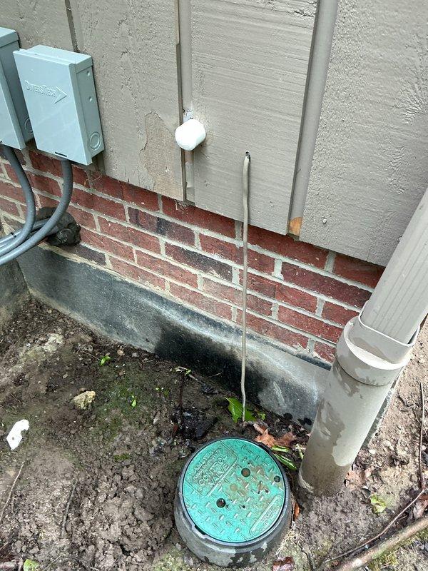 Successfully abandoned and decommissioned the irrigation system by excavating around the exterior PVC supply line, cutting and capping the pipe at the foundation penetration point. Installed caps on both the interior and exterior ends of the through-wall pipe to seal the penetration. Shut off the main water supply and removed the irrigation system tee fitting from the domestic water line by unsweating the copper connections, then installed a copper elbow to restore direct flow and eliminate the abandoned branch. All work completed to ensure proper water flow to the residence while permanently isolating the defunct irrigation system.