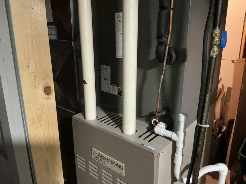 Conducted furnace replacement estimate at residential property. Evaluated existing Armstrong air handler unit and associated HVAC system components in basement mechanical room. Documented current equipment configuration including high-efficiency furnace with PVC intake and exhaust venting, water heater, copper and gas piping infrastructure, and overall system layout to provide comprehensive replacement recommendations.
