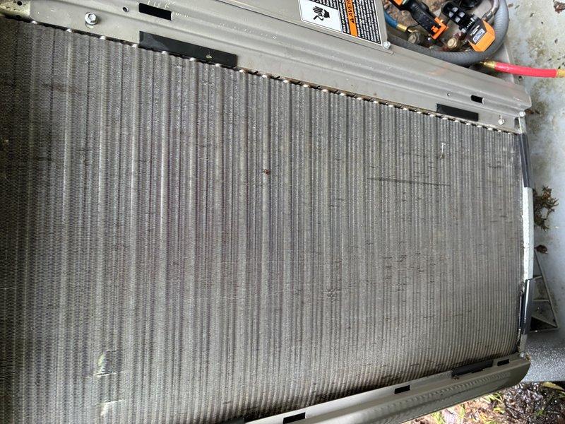 Completed comprehensive tune-up on 7-year-old residential air conditioning system. Performed thorough inspection of outdoor condenser unit, noting significant debris accumulation within fin coil assembly requiring attention. Assessed electrical control panel and wiring connections, documenting existing installation condition. All critical components evaluated for proper operation and seasonal readiness.