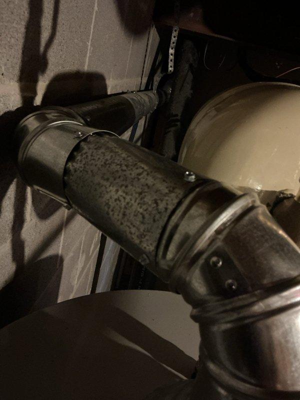 Completed warranty repair following failed inspection. Installed required drain pan and secured flue pipe connections with three screws per code requirements. Documented all repairs with photographs and notified permits department for re-inspection scheduling.