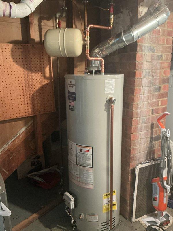 Completed installation of 40-gallon residential water heater in basement utility area. Installed new unit with expansion tank, copper supply piping, shut-off valves, and all necessary fittings and connections per manufacturer specifications. All components were pre-staged with water heater installation kit prior to service appointment to ensure efficient completion.