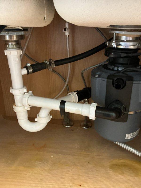 Provided quote for installation of customer-supplied kitchen faucet. Addressed callback regarding recently installed Moen faucet experiencing excessive water pressure issues. Assessed plumbing system and recommended pressure regulation adjustment to resolve high-pressure condition at fixture. Documented existing double-basin sink installation with functioning garbage disposal and standard P-trap drainage configuration.