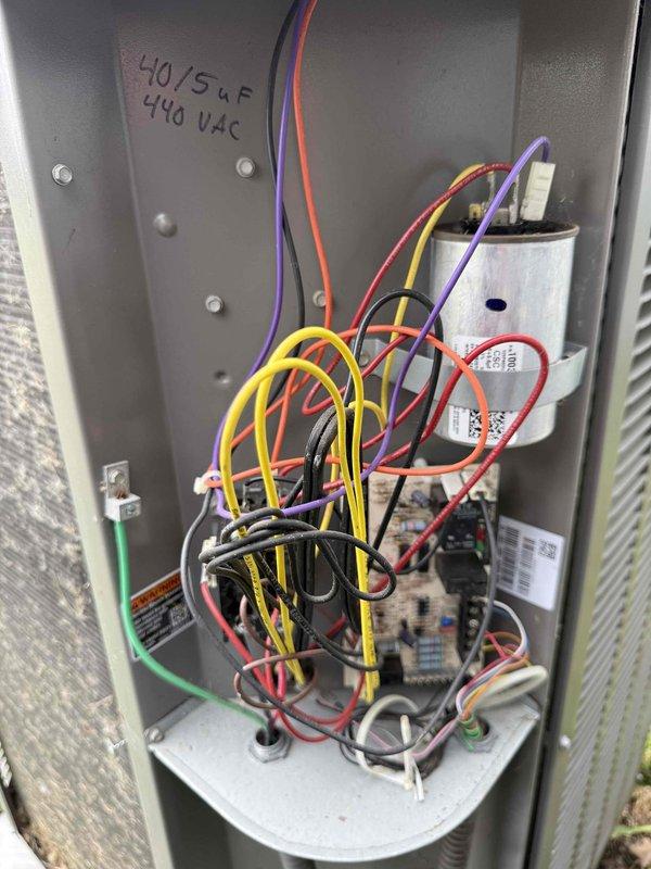 Performed routine HVAC maintenance inspection for MVP customer's air conditioning system. Accessed and inspected electrical compartment, documenting dual-run capacitor rated at 40/5µF 440VAC and verifying proper wire connections across all terminals. Examined mechanical components including mounting hardware and spring assemblies to ensure secure operation and proper system functionality.