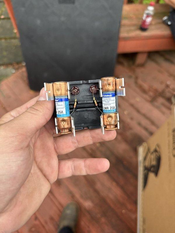 Completed installation of new air conditioning system including outdoor condensing unit and evaporator coil. Replaced failed contactor showing heat damage and discoloration on copper terminals with new 25A rated component. System installed against exterior wall with proper electrical disconnect, conduit connections, and positioning for optimal airflow and serviceability.