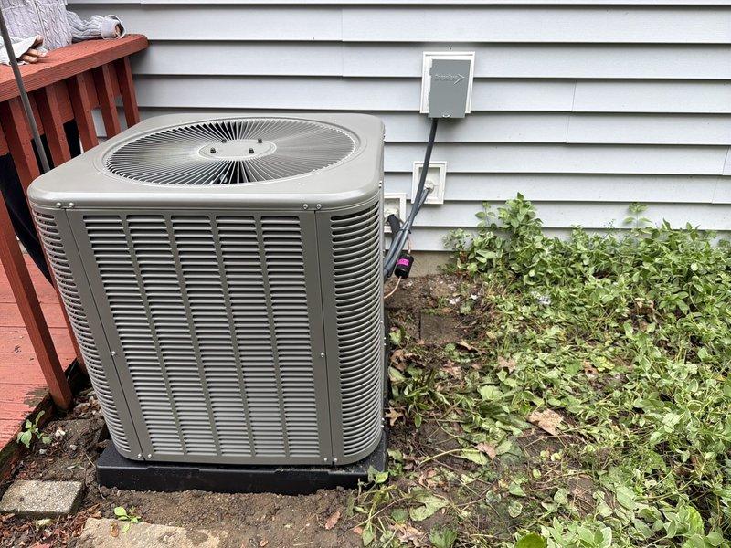 Completed installation of new air conditioning system including outdoor condensing unit and evaporator coil. Replaced failed contactor showing heat damage and discoloration on copper terminals with new 25A rated component. System installed against exterior wall with proper electrical disconnect, conduit connections, and positioning for optimal airflow and serviceability.
